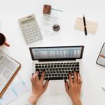 aerial-view-businessman-using-computer-laptop-1-e1646166176490